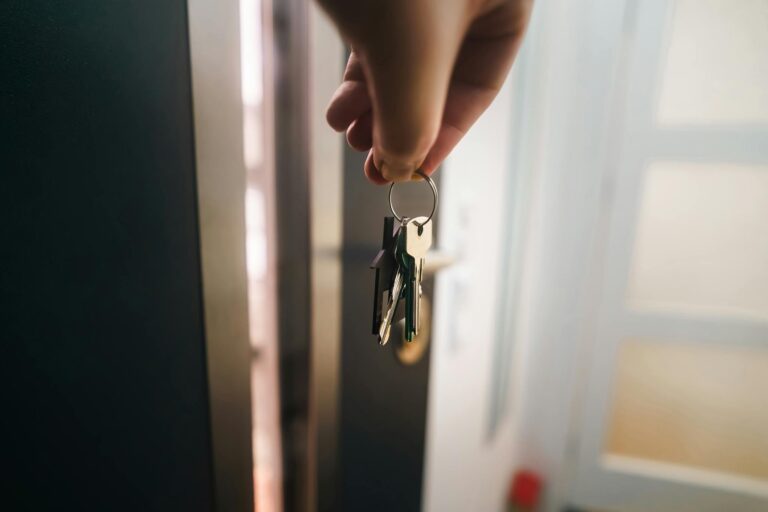 Close-up of a hand holding keys, symbolizing home ownership or rental entry.